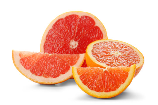 Colorful citrus slices and halves of grapefruit and orange isolated on a white background, close up