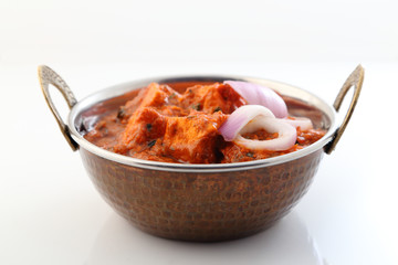 Indian style food or Indian Curry in a copper brass bowl.