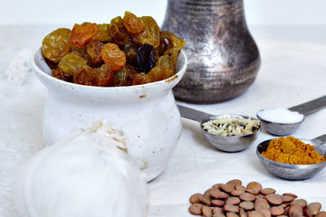 Indian cuisine ingredients including lentils, garlic, fennel, raisins, curry and salt.