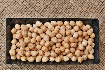 Chickpeas in black plate on the gunny cloth