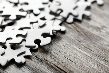 Puzzles on wooden table, closeup