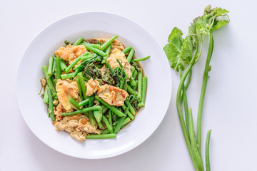 Fried green vegetable with egg.
