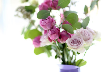 Beautiful bouquet of roses on light blurred background