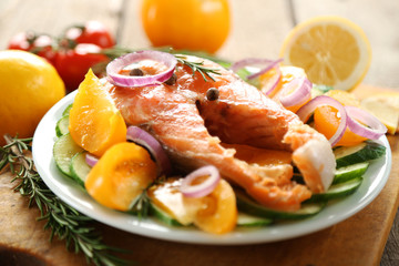 Fish with vegetables on plate