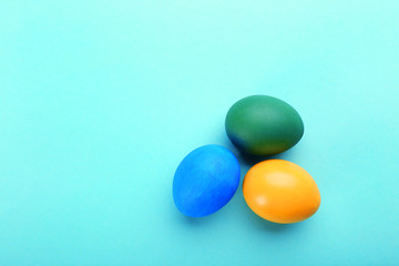 Easter eggs on a blue table, top view