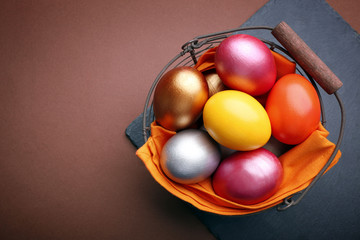 Easter eggs in a basket, top view