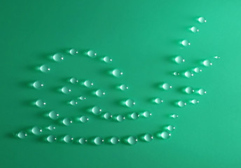 Snail made of water drops on green background