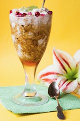 Porridge dessert with flower on yellow background
