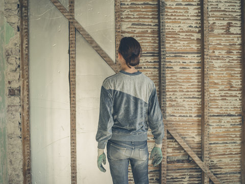 Young woman insulating walls