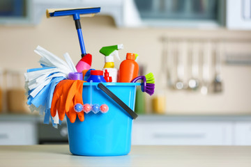 Cleaning set with products and tools in blue bucket