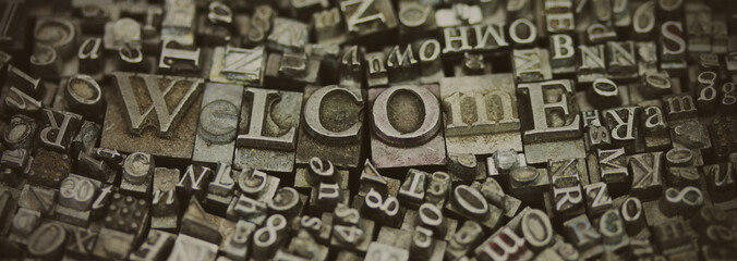 Close up of typeset letters with the word Welcome