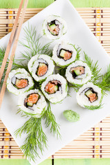 Uramaki sushi with cucumber, raw salmon and dill