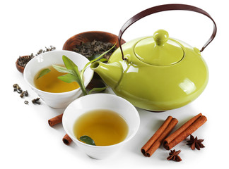 Green tea with utensils and spices, isolated on white