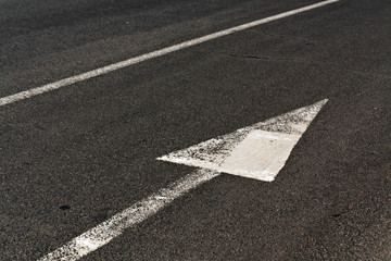 Line and arrow on asphalt surface