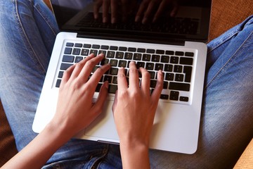 Fototapeta premium Young female hands working on laptop