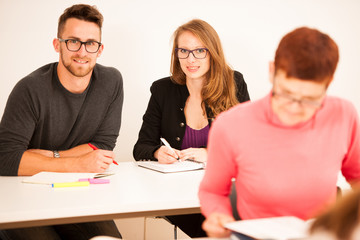 Group of people of different age sitting in classroom and attend
