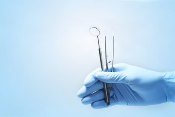 Close-up of dentist's hands and dental equipment