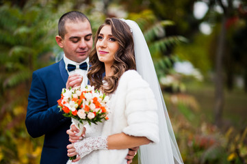 Happy wedding couple in love at autumn park