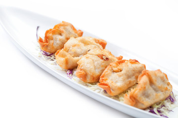 gyoza on a white dish.