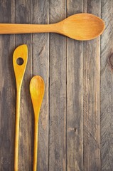 Wooden kitchen spatulas and spoons on a vintage table