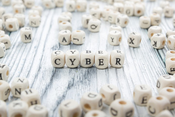 Cyber word written on wood block. Wooden Abc