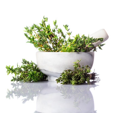 Green Thyme in Pestle and Mortar on White Background
