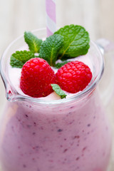 Raspberry milk shake with mint decor.