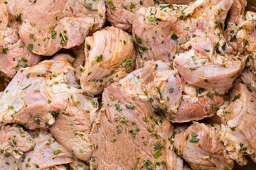 Fresh pork meat pieces in marinade.