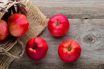Ripe red apples on wooden background.