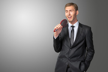 Young Businessman singing as if in microphone