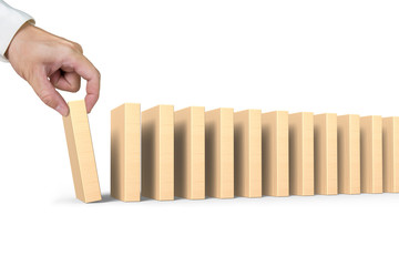 Human hand putting domino in line