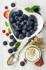 Healthy breakfast of muesli, berries with yogurt and seeds