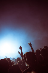 Beer and hands in the air during a live electronic techno concert in a pop venue