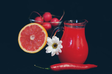 red juices in glasses and fruits and vegetables