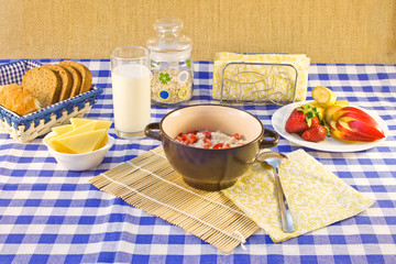 Still life breakfast of oat porridge with strawberries on a chec