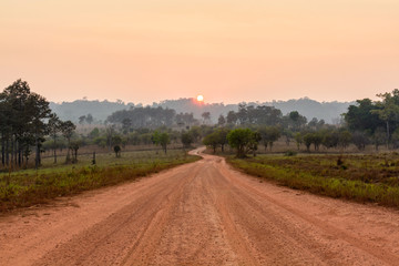 curve road in the valley with sunrise and mist