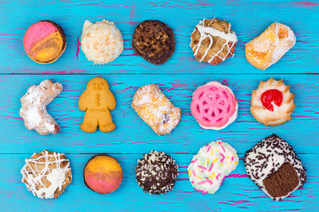 Assortment of colorful cookies on blue wood