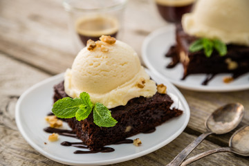 Chocolate brownie with vanilla ice cream, nuts and mint