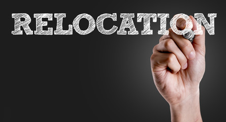 Hand writing the text: Relocation