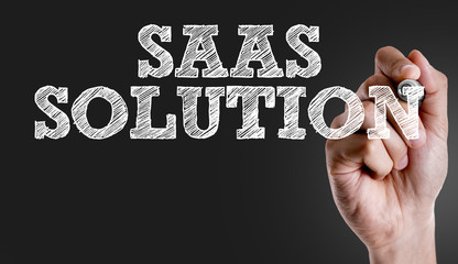 Hand writing the text: Saas Solution