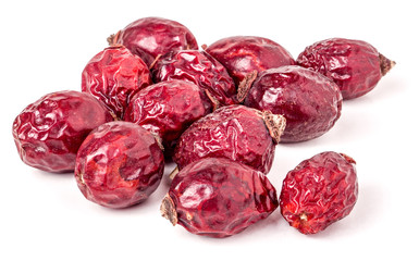 Heap berries dried rosehips isolated on white.