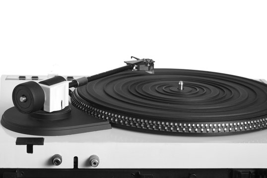 Turntable with right tonearm in silver case with rubber mat on black disc with stroboscope marks with output connectors rear view isolated on white background. Horizontal view closeup
