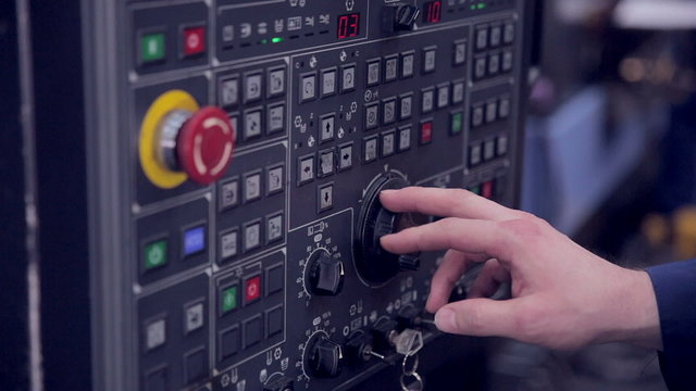 Factory Worker is Setting Up CNC Lathe Machine in Factory.  HD.