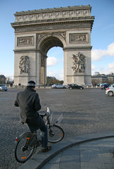 PARIS, FRANCE - NOVEMBER 27, 2009: Cyclist near the Arc de Triomphe on Place Charles de Gaulle in Paris