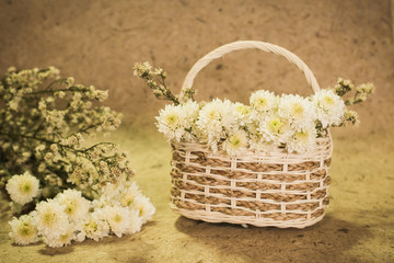 Fototapeta na wymiar white flowers on basket vintage
