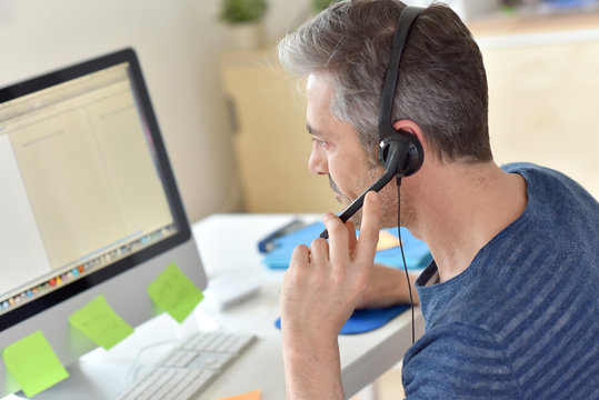 Closeup of telemarketing worker in office
