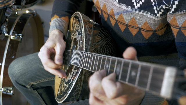 	Young man playing on turkish saz guitar, 4k