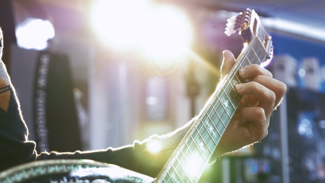 Young man playing on turkish saz guitar, 4k