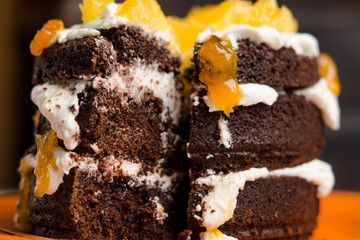 Chocolate cake with oranges on the wooden background