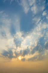 Fototapeta na wymiar sunset sky with rays of light shining down pass clouds and sky